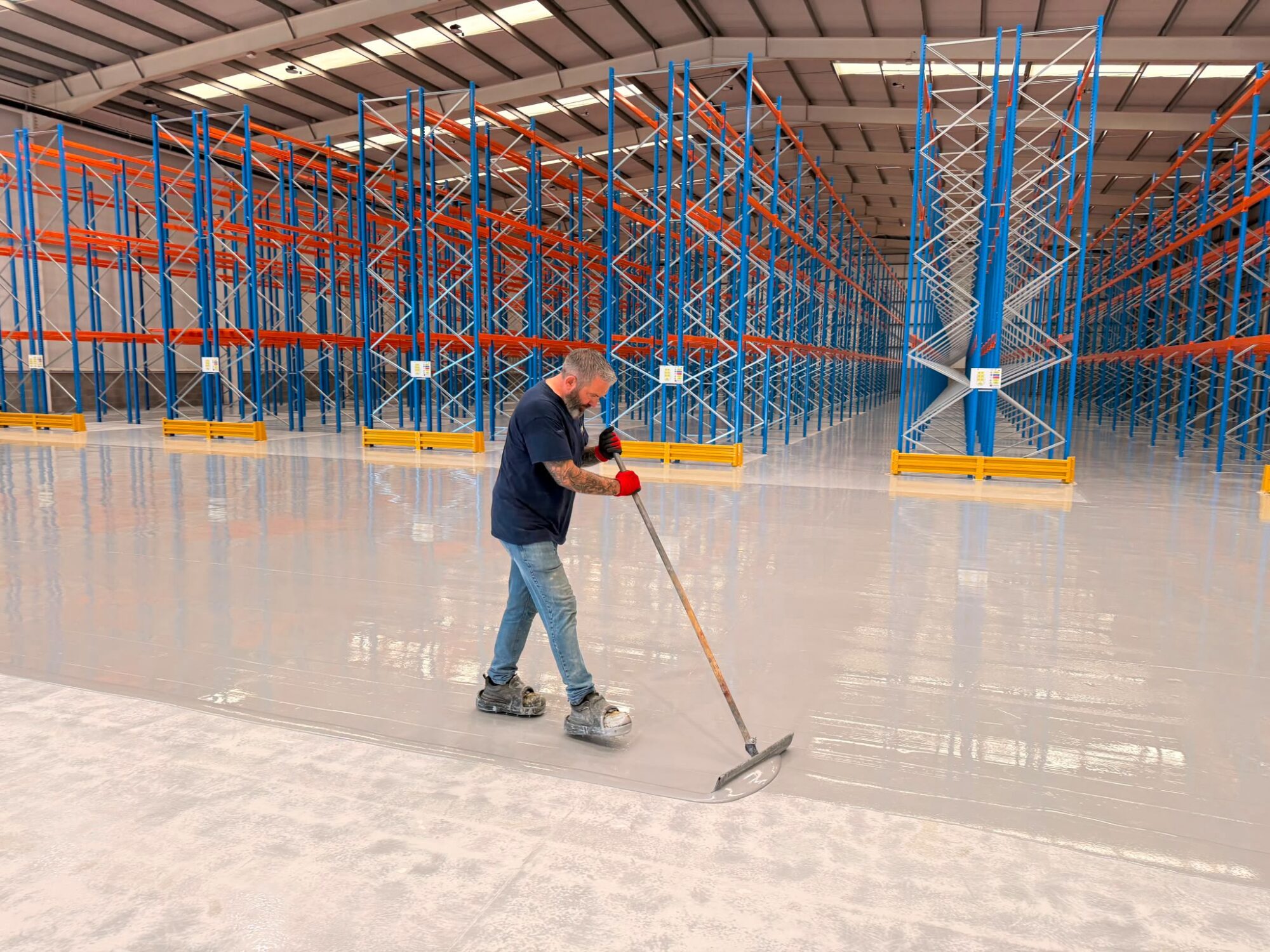 REME Flooring installing resin flooring in warehouse facility